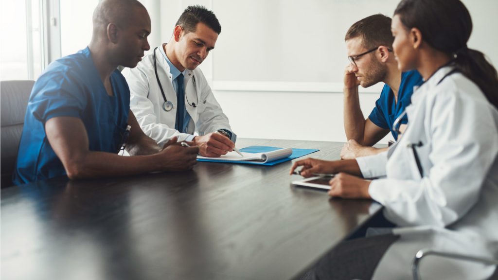 Doctors discussing around a table